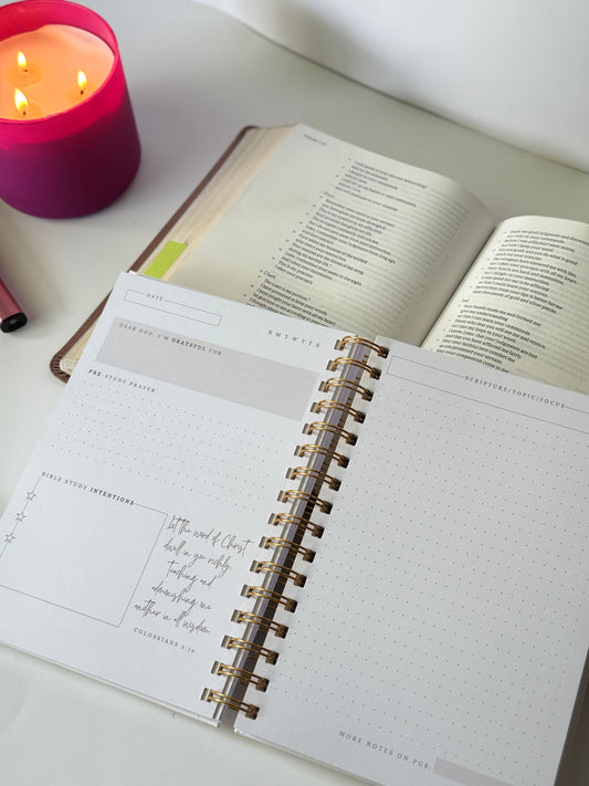 Bible study journal flat lay with Bible and candle